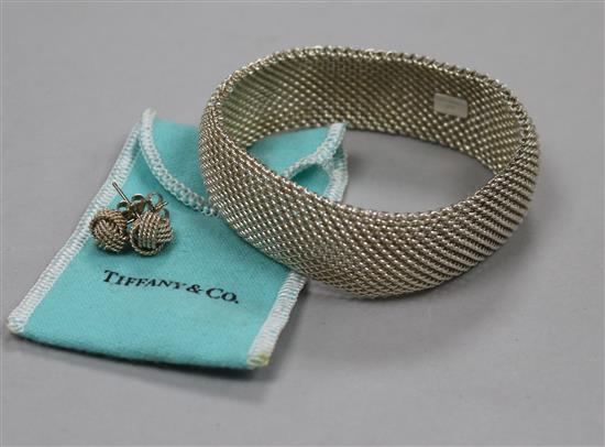 A Tiffany & Co sterling silver mesh link bracelet, a Pair of similar knot ear studs and a Tiffany & Co silver gilt heart pendant.